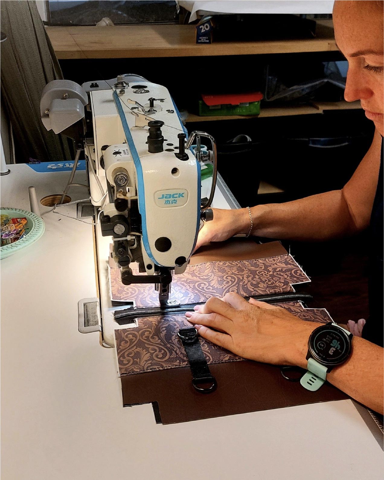 woman sewing tooled floral bag at sewing machine
