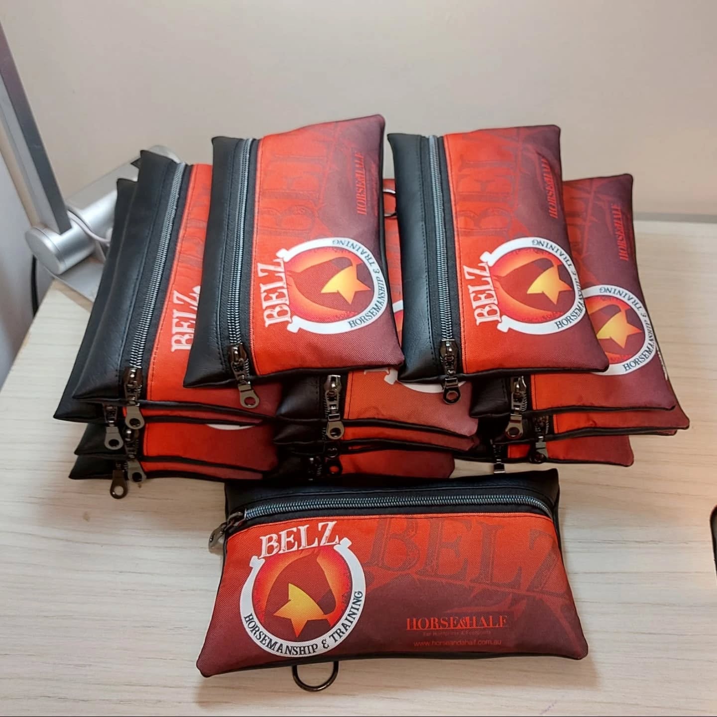 Red and black bags with 'BELL' branding on a light surface.