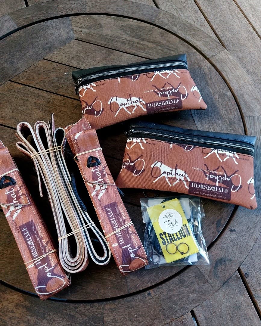 Collection of horse-related products including bags and straps on a wooden surface